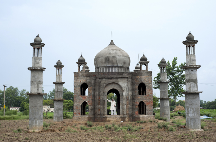 Mr Quadri stands in the doorway of his Taj-Mahal inspired mausoleum