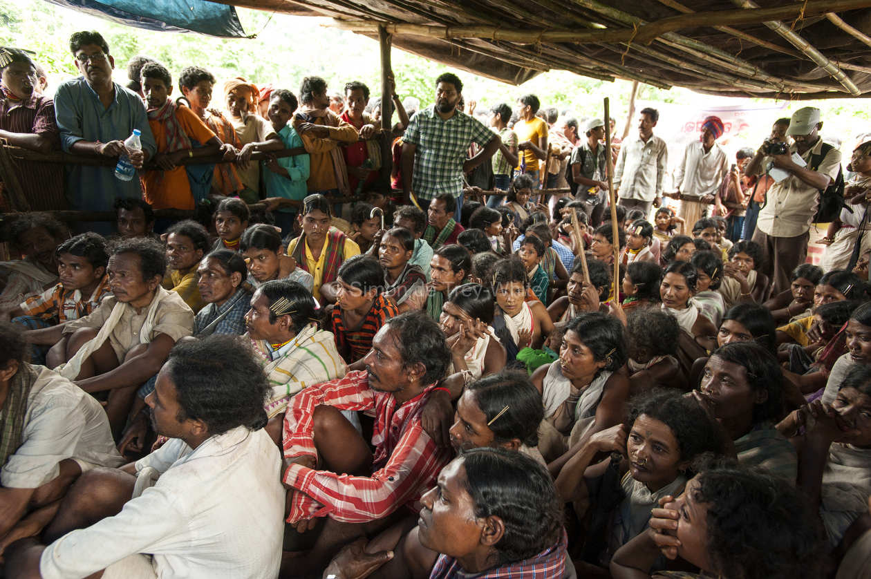 Dongria Kondha villagers observe and listen to proceedings from inside the Gram Sabha meeting hall